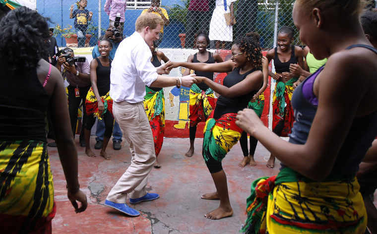 Image: Britain's Prince Harry dances with Dormer at a youth community center in Kingston, Jamaica